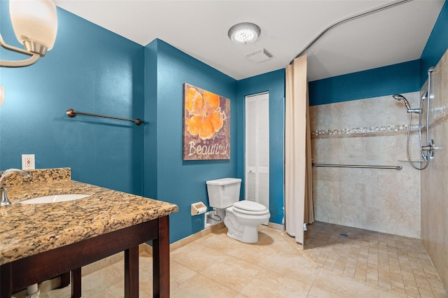 bathroom featuring tile patterned floors, toilet, walk in shower, and sink