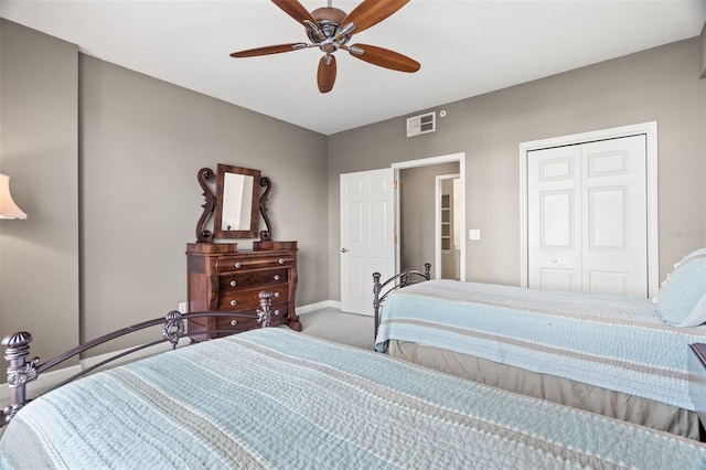 carpeted bedroom featuring ceiling fan and a closet