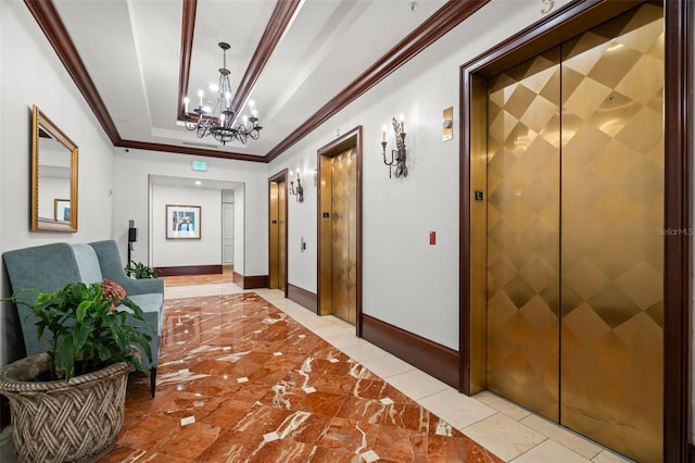 corridor featuring ornamental molding, elevator, a tray ceiling, and a notable chandelier