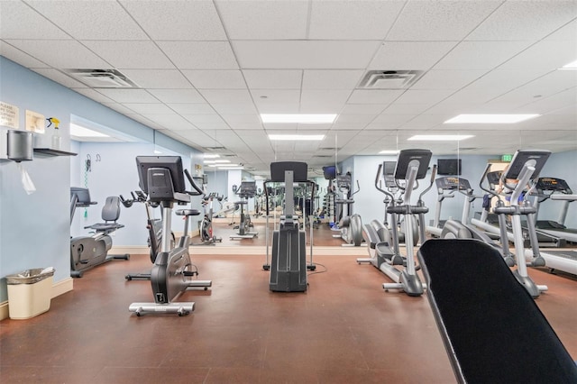 gym with a paneled ceiling