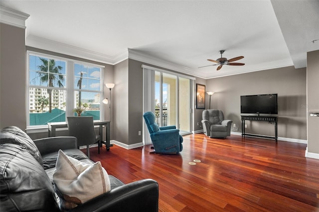 living room with ornamental molding, dark hardwood / wood-style floors, and a healthy amount of sunlight