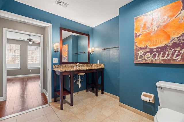 bathroom with ceiling fan, sink, tile patterned flooring, and toilet