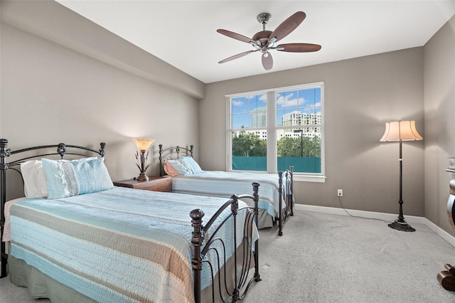 bedroom with ceiling fan and light carpet