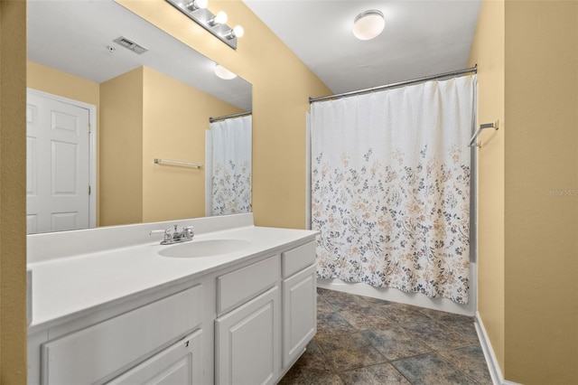 bathroom with shower / tub combo with curtain and vanity