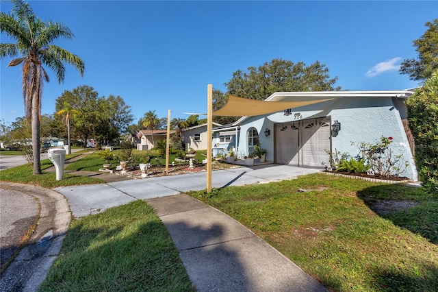 view of front facade featuring a front yard and a garage