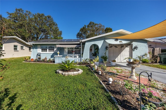 ranch-style house with solar panels, a porch, a garage, and a front lawn