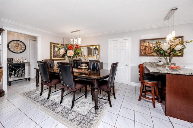 tiled dining room featuring ornamental molding and a chandelier