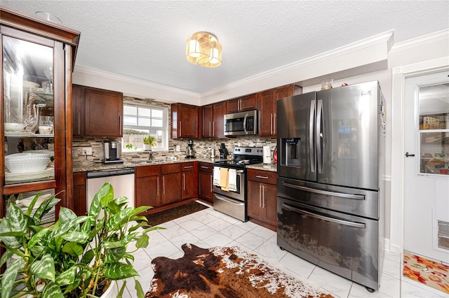 kitchen with stone countertops, ornamental molding, stainless steel appliances, and tasteful backsplash