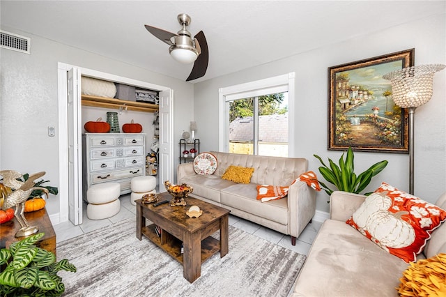 living room featuring ceiling fan and light tile patterned floors