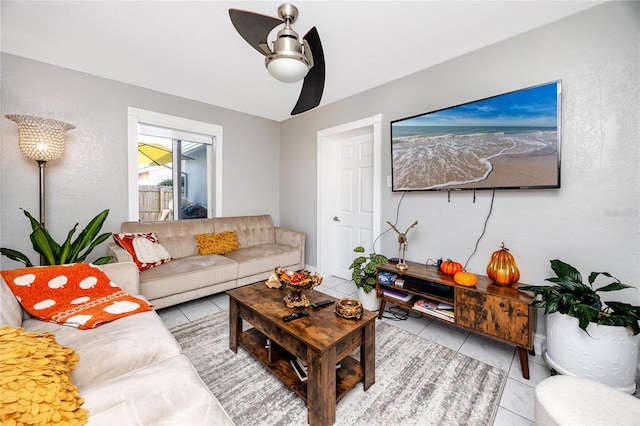 tiled living room featuring ceiling fan