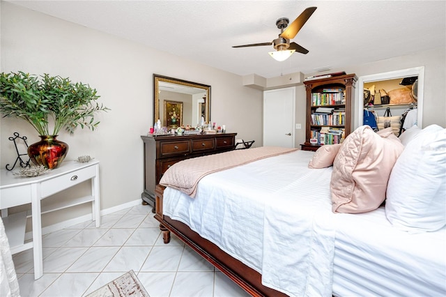 bedroom with a textured ceiling, ceiling fan, a spacious closet, a closet, and light tile patterned flooring