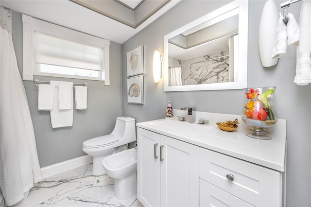 bathroom featuring vanity, toilet, and a bidet