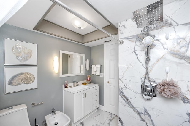 bathroom featuring vanity, toilet, and a bidet