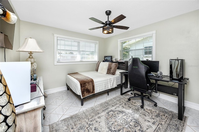 bedroom with ceiling fan and light tile patterned floors