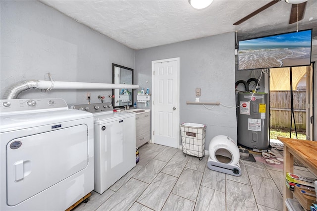 clothes washing area with ceiling fan, washing machine and dryer, electric water heater, and a textured ceiling