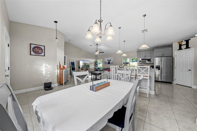 dining area featuring light tile patterned floors, ceiling fan with notable chandelier, and lofted ceiling