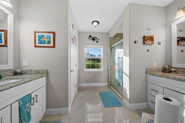 bathroom featuring tile patterned flooring, vanity, and walk in shower