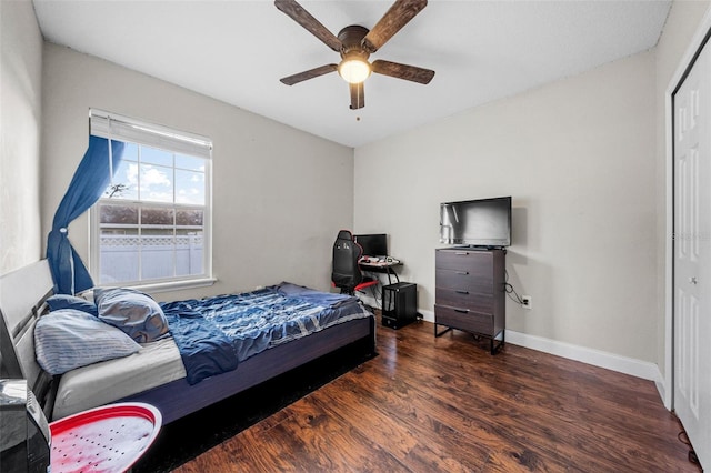 bedroom with ceiling fan, dark hardwood / wood-style floors, and a closet