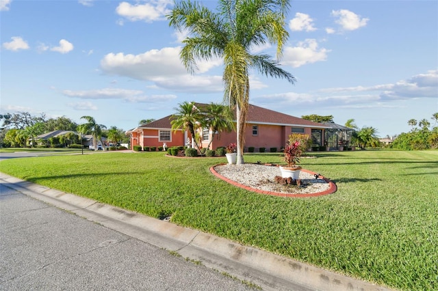 ranch-style home featuring a front lawn