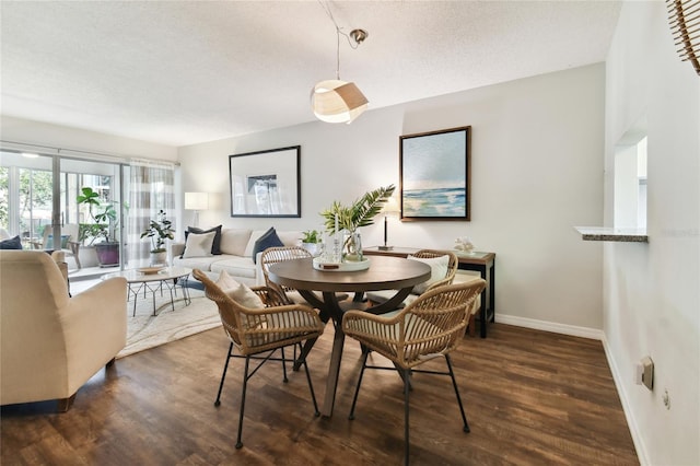 dining room featuring dark hardwood / wood-style floors and a textured ceiling