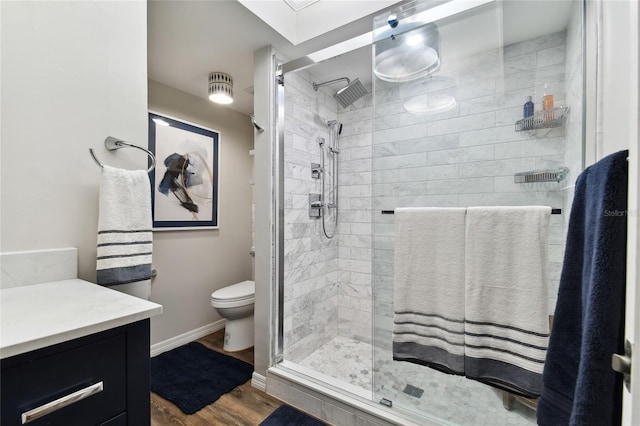 bathroom featuring hardwood / wood-style floors, vanity, toilet, and an enclosed shower