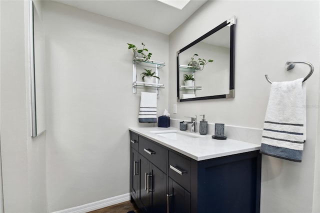 bathroom with hardwood / wood-style floors and vanity