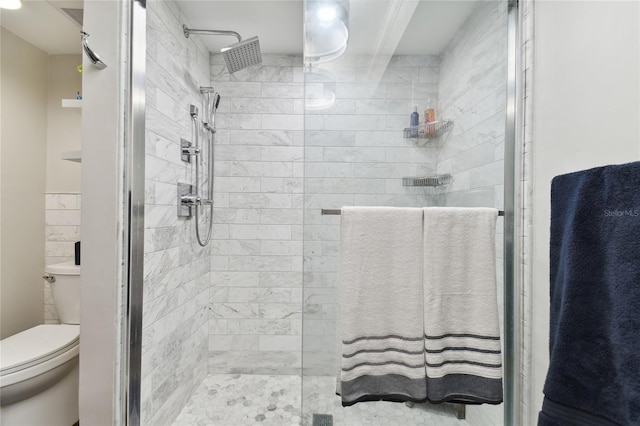 bathroom with toilet and a shower with shower door