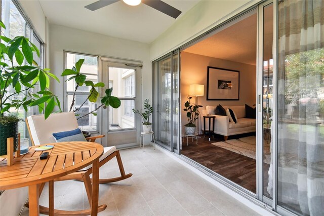 sunroom featuring ceiling fan