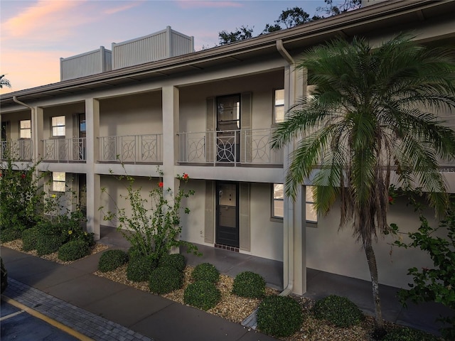 view of outdoor building at dusk