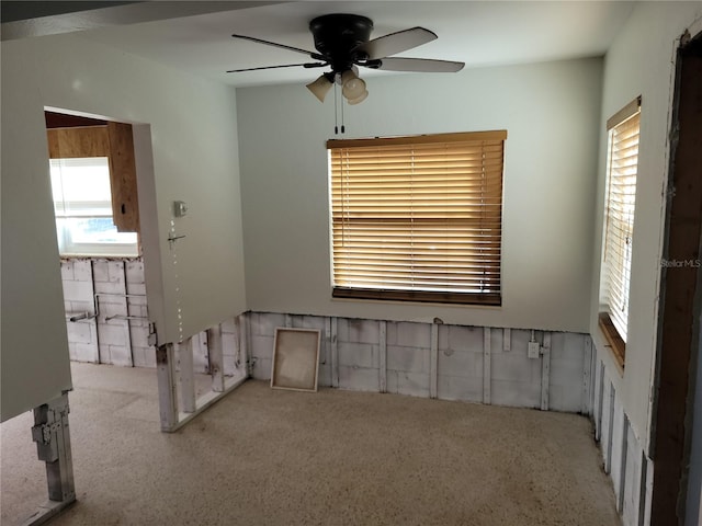 carpeted spare room with ceiling fan