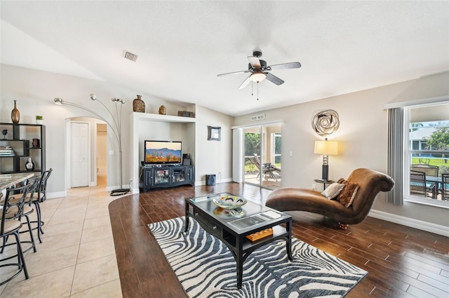 living room featuring ceiling fan and light hardwood / wood-style flooring