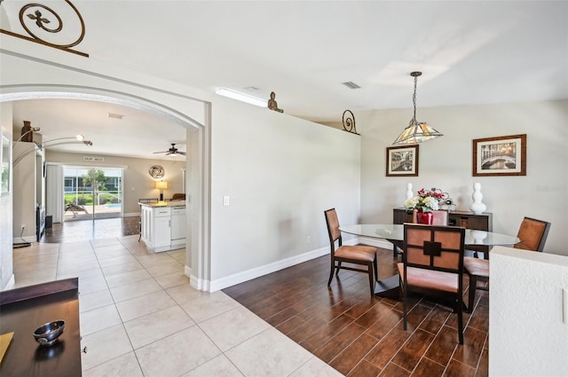 dining room with ceiling fan, light hardwood / wood-style floors, and lofted ceiling