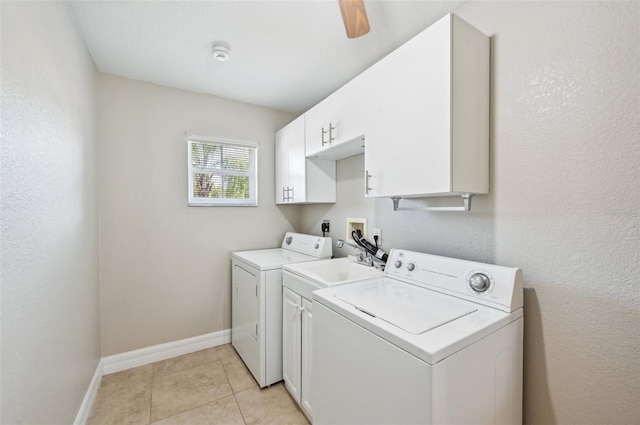 laundry room with washing machine and clothes dryer, ceiling fan, light tile patterned floors, and cabinets