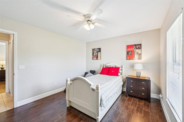 bedroom with dark hardwood / wood-style flooring and ceiling fan