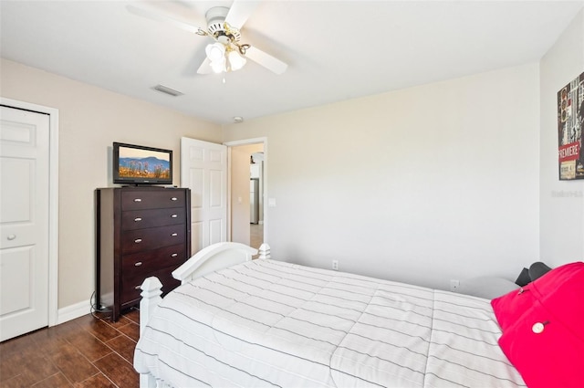 bedroom with ceiling fan and dark hardwood / wood-style floors