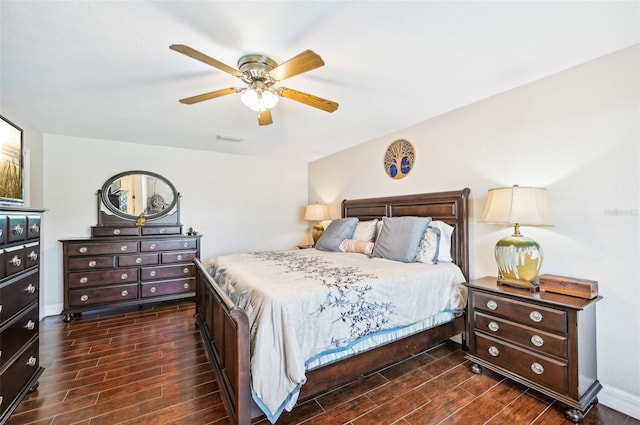 bedroom with dark hardwood / wood-style flooring and ceiling fan