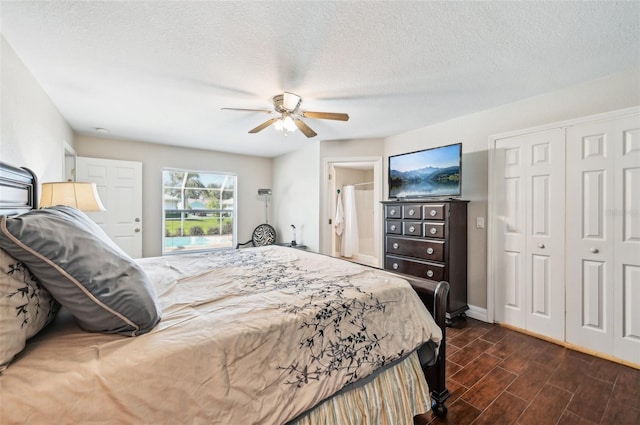 bedroom featuring ceiling fan, dark hardwood / wood-style flooring, and a textured ceiling