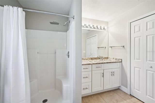 bathroom with vanity, tile patterned floors, and curtained shower