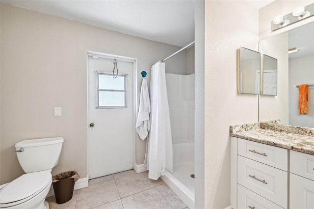 bathroom with tile patterned floors, toilet, vanity, and a shower with shower curtain