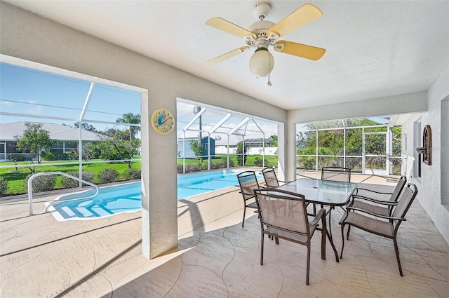 view of pool with a patio, ceiling fan, and a lanai