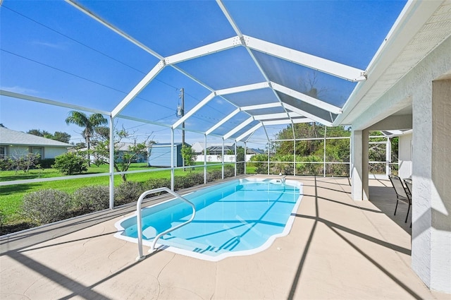 view of swimming pool featuring glass enclosure, a patio, and a storage unit