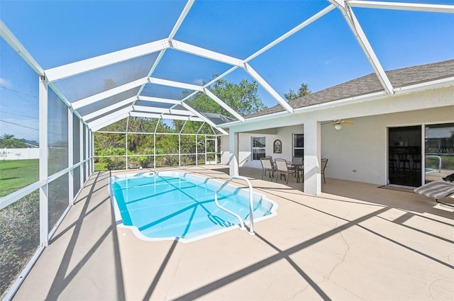 view of pool featuring a lanai, a patio area, and ceiling fan