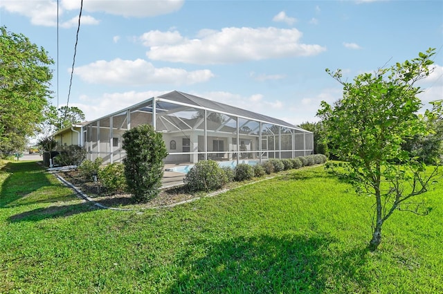 exterior space with a yard, a pool, and a lanai