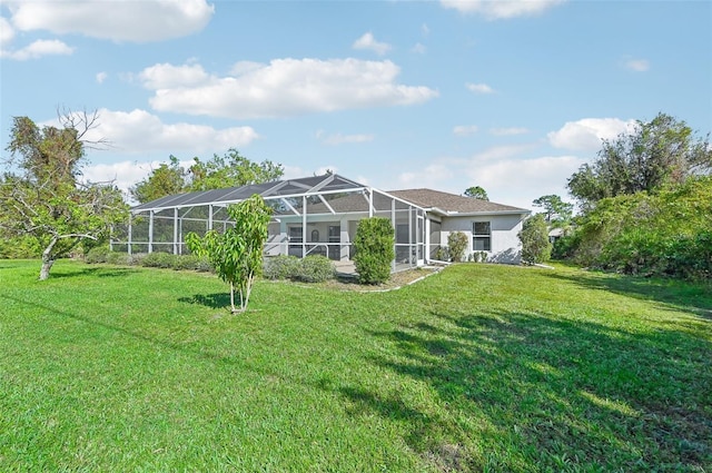 rear view of property with a lawn and glass enclosure