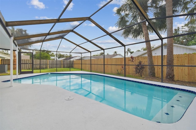 view of swimming pool featuring glass enclosure