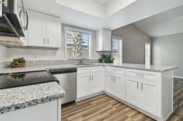 kitchen with appliances with stainless steel finishes, light hardwood / wood-style flooring, white cabinetry, and sink