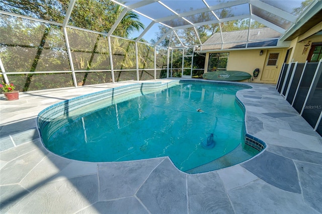 view of pool featuring a lanai and a patio