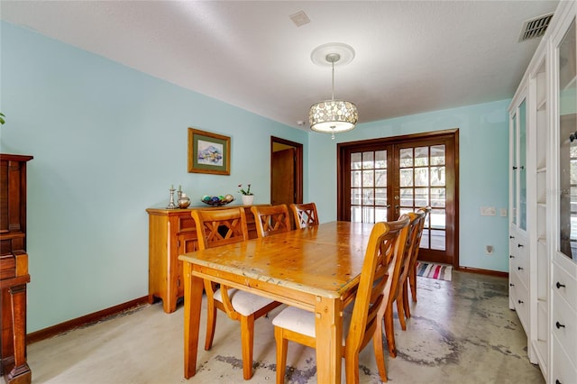 dining area featuring french doors and a textured ceiling