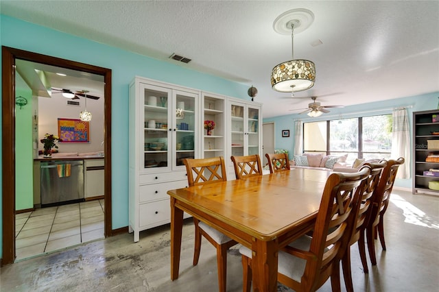 dining room featuring a textured ceiling and ceiling fan