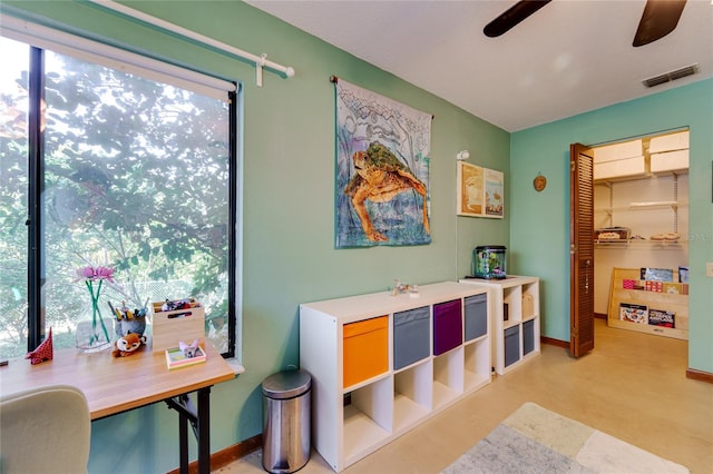 interior space with baseboards, visible vents, and a ceiling fan